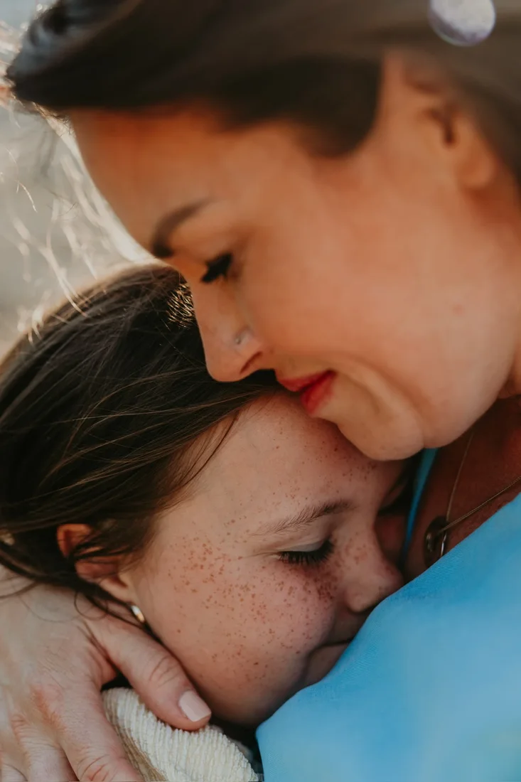 Mother and daughter foreheads together, close-up