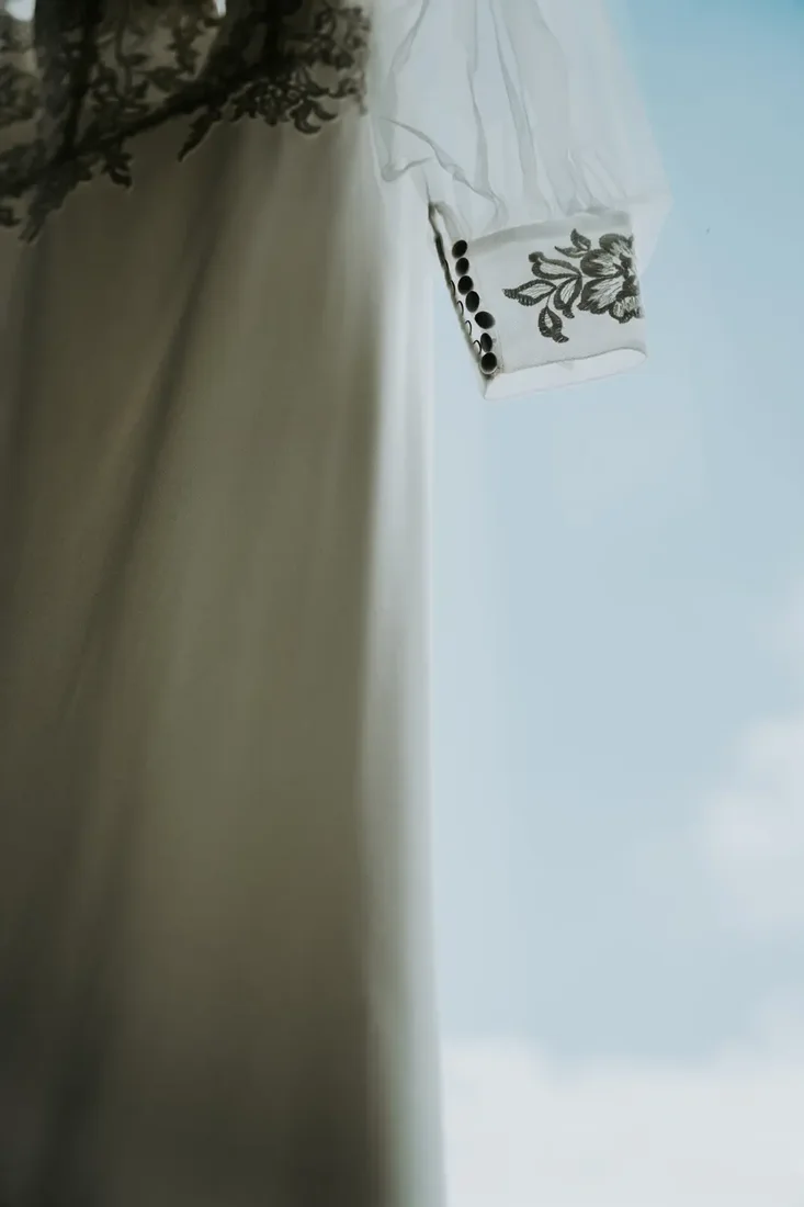 Wedding dress and veil detail against the sky